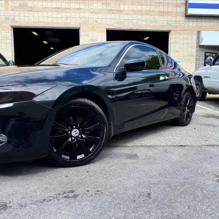 Black car parked outside a storefront.